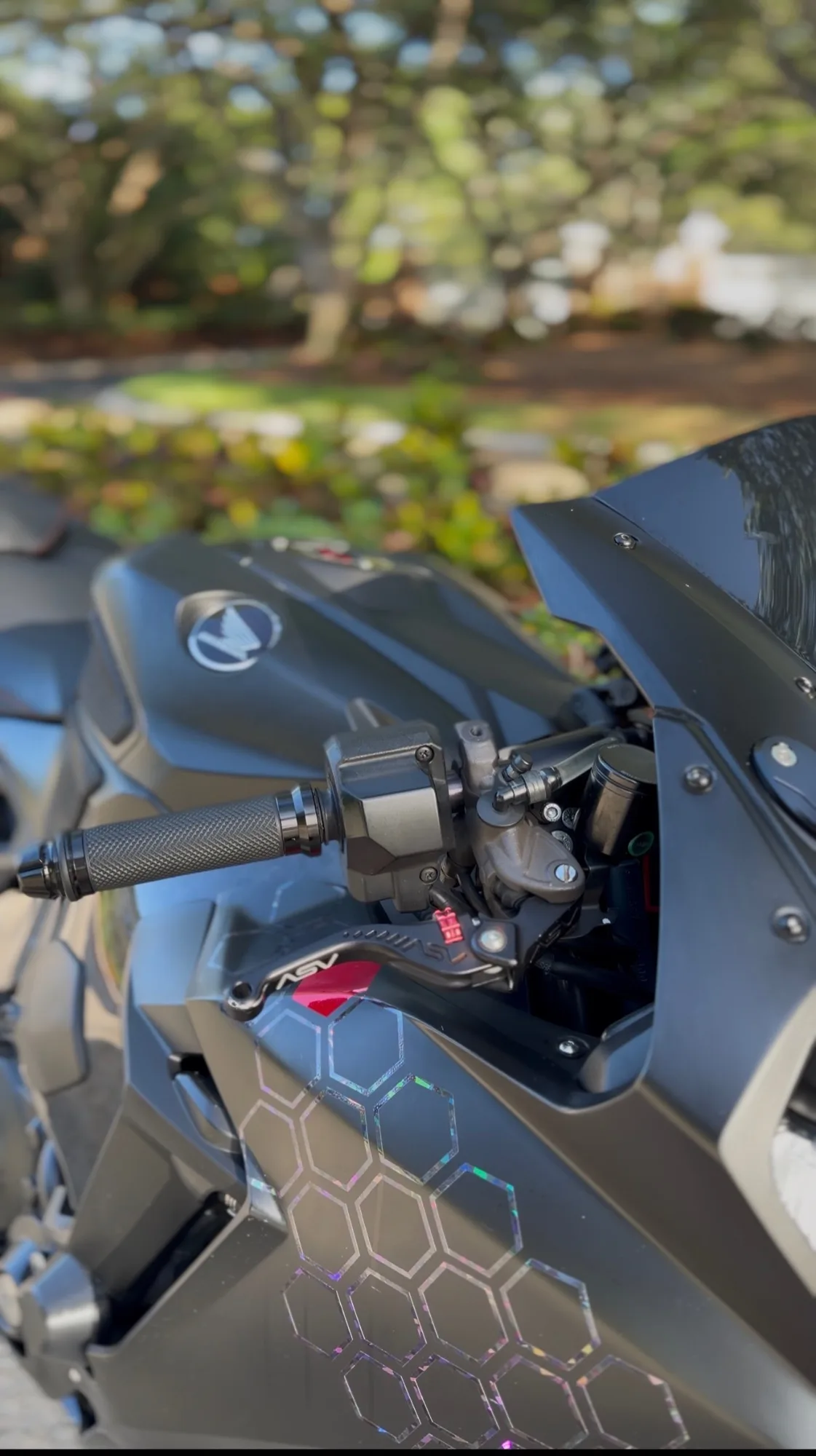 Detail of a custom-patterned motorcycle tank and controls